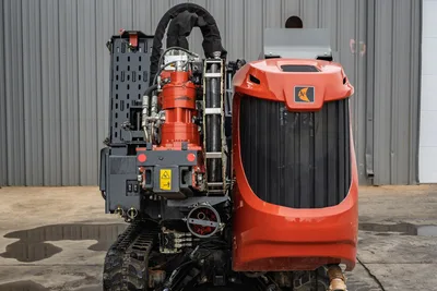 2024 Ditch Witch JT24 rear view showing spindle, hydraulic lines, vise assembly, rubber tracks, and red engine hood with logo