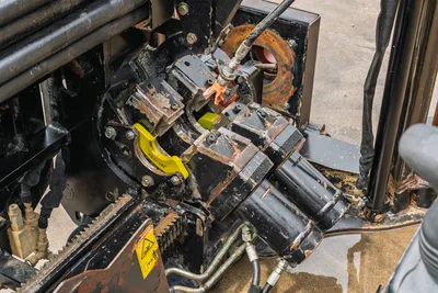 2018 Ditch Witch JT10 vise wrench assembly with hydraulic cylinders, drill pipe guides, and pivot point closeup perspective.