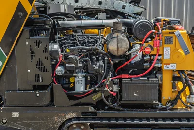 Vermeer 10x15 S3 engine compartment side view showing 60hp diesel engine, radiator, drill pipe, control panel, and hydraulic components