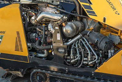 2021 Vermeer D23x30 S3 HDD rig open engine compartment showing 100hp diesel, exhaust, hydraulic lines, and DCI locator mount