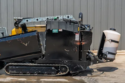 2021 Vermeer D8x12 HDD drill rear quarter view showing rubber tracks, diesel fuel tank, fluid mixing tank, and drill pipe carriage