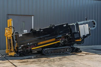 2016 Vermeer D23x30 S3 HDD drill angled upright on rubber tracks, yellow pipe loader, black enclosure, hydraulic lines visible