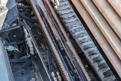 Ditch Witch JT10 drill pipe and rotary head assembly with rack drive track visible, close-up detail view