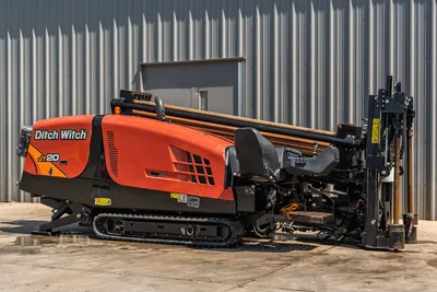 2022 Ditch Witch JT20 HDD drill, side view, orange hood, rubber tracks, loaded drill pipe rack, operator seat, anchor system visible