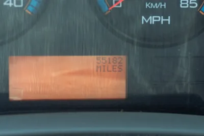 2015 International 7400 mud truck odometer display showing 55,182 miles on orange digital readout with speedometer gauges visible