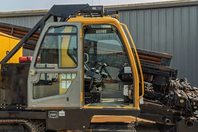 2017 Vermeer D100x140 S3 open operator cab, dual joystick controls, drill pipe rack loaded, hydraulic components visible