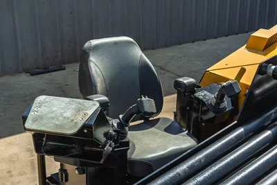 2022 Vermeer D23x30 S3 operator seat, joystick controls, armrests, and drill pipe rack visible, close-up angle