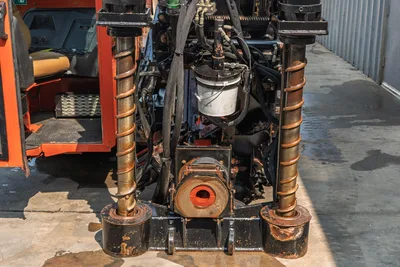2017 Ditch Witch JT30 rear-facing view showing vise assembly, dual anchor posts, pipe spinner, hydraulic hoses, and operator station