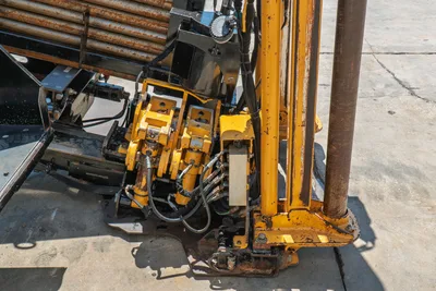 2020 Vermeer D24x40 S3 carriage and spindle drive close-up, hydraulic lines, drill rod loaded in rack, yellow frame