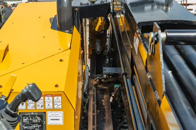 2022 Vermeer D23x30 S3 drill frame close-up showing carriage rack, thrust chain, spindle, hydraulic motor, and drill rod box overhead view