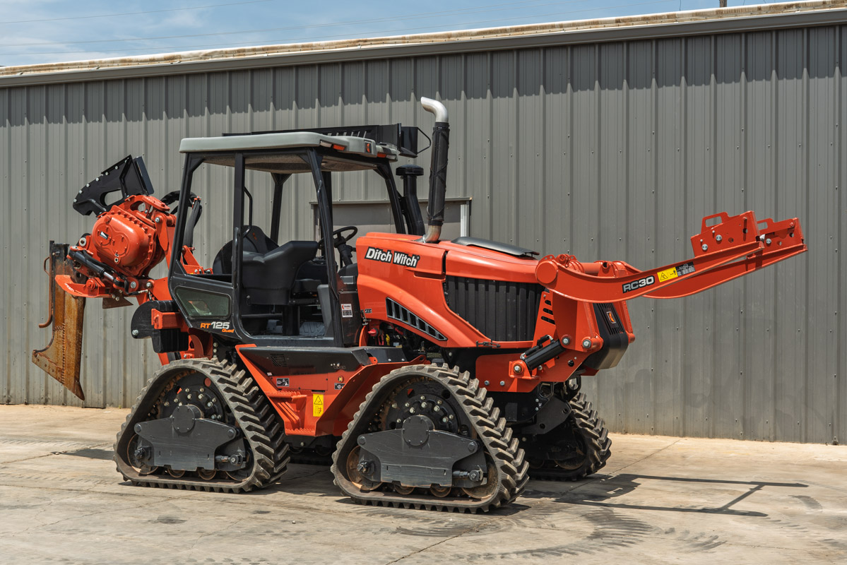 2024 Ditch Witch RT125Q quad-track trencher, enclosed cab, RC30 attachment, chain trencher boom, 3/4 front angle view, low hours