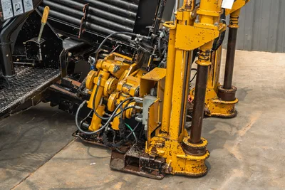 Vermeer 24x40 Series II drill rig side view showing hydraulic stabilizers, drill rod rack, and high-pressure hose assembly.
