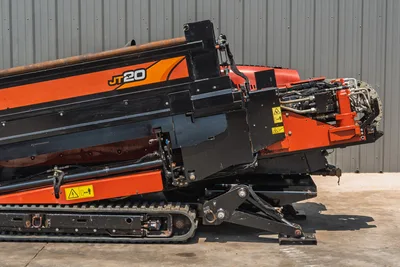 2021 Ditch Witch JT20 HDD drill, side-angle view of elevated drill frame, carriage, hydraulic lines, rubber tracks, and anchor systems visible.
