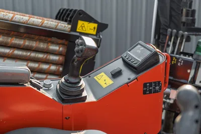 2021 Ditch Witch JT28 operator console, joystick controls, digital display monitor, yellow warning labels, drill pipe rack visible background