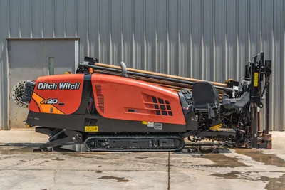 2023 Ditch Witch JT20 HDD rig, driver-side profile view, rubber tracks, loaded drill pipe rack, carriage assembly, operator controls visible