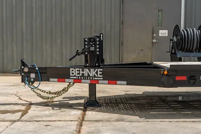 2026 Behnke CBCT2324E-BT-R trailer tongue, adjustable ball hitch, drop-leg jack, safety chains, brake line, reflective tape, side view