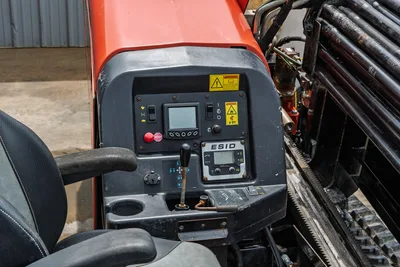 2018 Ditch Witch JT10 operator console with ESID display, joystick controls, toggle switches, red hood, drill pipe rack visible
