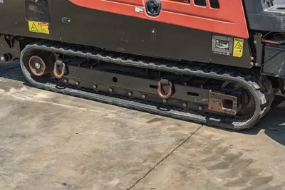 2018 Ditch Witch JT30 All Terrain rubber track close-up showing D-ring tie-downs, undercarriage frame, and safety decals