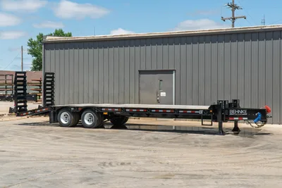 2026 Behnke FB8X30SDPT-40L flatbed pintle hitch trailer, full side profile, black steel deck, tandem axles, fold-down ramps