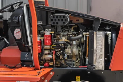 Open engine compartment of 2017 Ditch Witch RT80 showing clean motor, cooling system, and critical filters. Side profile.