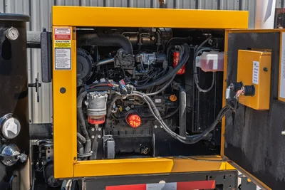 2025 Vermeer LP873SDT vacuum excavator open engine compartment showing diesel engine, fuel filter, hoses, and warning labels