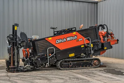 2024 Ditch Witch JT24 HDD drill, side view, angled carriage raised, rubber tracks, drill frame, hydraulic components visible