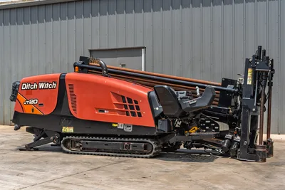 2017 Ditch Witch JT20 HDD rig, side view, orange enclosure, loaded drill pipe rack, carriage, anchor system, rubber tracks