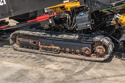 2020 Vermeer D24x40 S3 rubber track close-up showing worn undercarriage, drive sprocket, hydraulic lines, and fluid reservoir