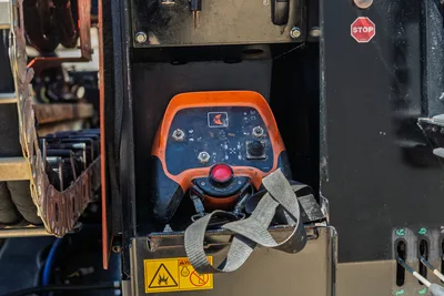 Ditch Witch JT30 All Terrain remote control station with harness and emergency stop button in storage compartment.