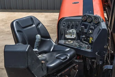 2017 Ditch Witch JT20 operator station showing black seat, ES10 display, gauge cluster, joystick controls, and toggle switches
