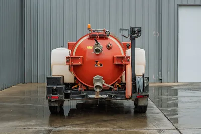 2021 Ditch Witch HX50 mud recycler, rear view, red cylindrical tank, fill ports, flex hose, side poly tanks, trailer hitch