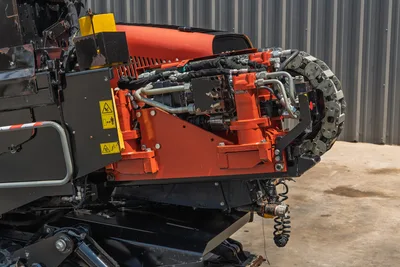 2023 Ditch Witch JT20 drill carriage close-up showing drive chain, hydraulic lines, spindle, and safety labels