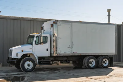 2000 Freightliner FL80 box mud truck, side profile view, featuring white cab and Morgan dry freight box body.