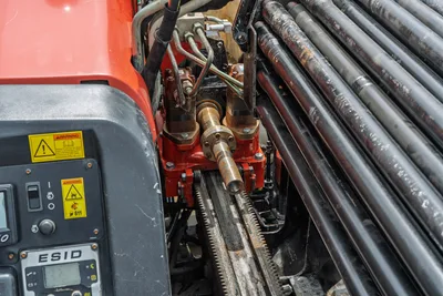 2018 Ditch Witch JT10 drill carriage, spindle, rack-and-pinion drive, ESID display, hydraulic lines, and loaded drill pipe rack