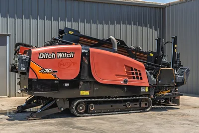 2018 Ditch Witch JT30 All Terrain HDD drill, driver-side view, rubber tracks, loaded drill pipe rack, orange bodywork, good condition