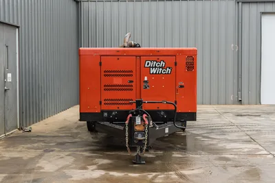 2023 Ditch Witch HX75 mud mixer, front view, trailer hitch with safety chains, red enclosure, exhaust stack, louvered access panels