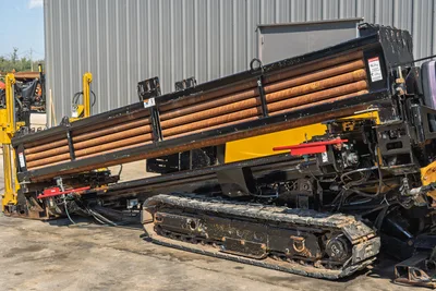 Vermeer D36x50 Series II HDD rig featuring elevated drill pipe racks, rubber tracks, and exposed powertrain components.