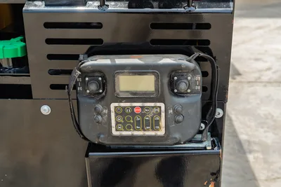 Vermeer D20x22 S3 remote control pendant with dual joysticks, LCD display, and function buttons, showing field wear