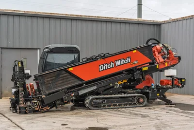 2021 Ditch Witch AT40 All Terrain HDD drill, side profile view showing tracks, cab, and raised drill pipe rack assembly.