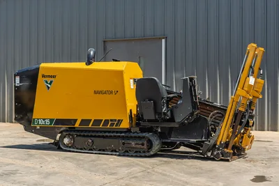 Vermeer D10x15 Navigator HDD unit with tracked carrier, yellow drill head tower, and control cab, side view