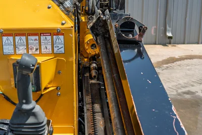 2021 Vermeer D8x12 drill frame close-up showing spindle, carriage rack, hydraulic rotary, joystick, and safety decals