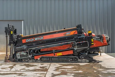2023 Ditch Witch JT20 HDD drill, side profile, drill frame angled up, drill pipe loaded, rubber tracks, hydraulic components visible